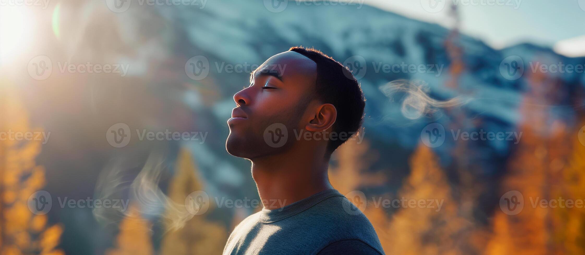Black man breaths fresh air on the forest. photo