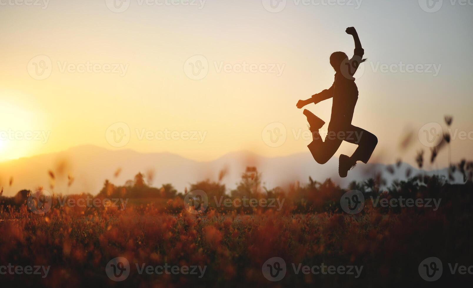 Silhouette of happiness and being free and relaxed in living life, success and working towards planned life goals. photo