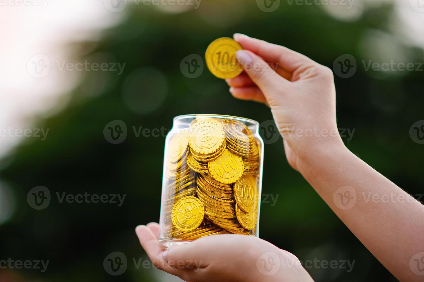 Gold coins in a glass jar, saving gold and investing in gold. Gold Market and Trading photo