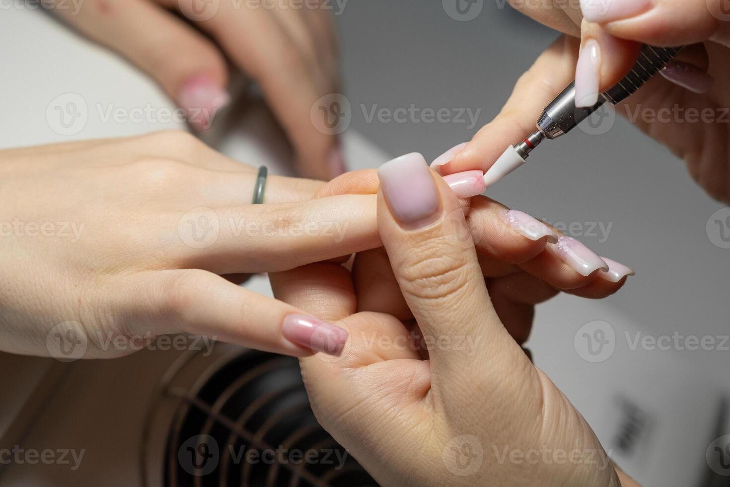 Female hands and tools for manicure, process of performing manicure photo
