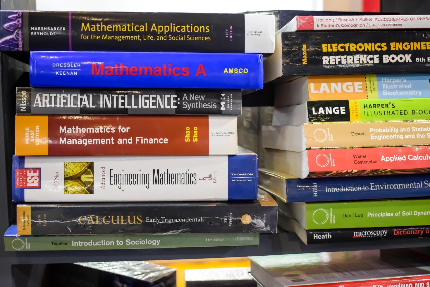 New Delhi, India, February 17 2024 - Variety of Books on shelf inside a book-stall at Delhi International Book Fair, Selection of books on display in Annual Book Fair at Bharat Mandapam complex photo