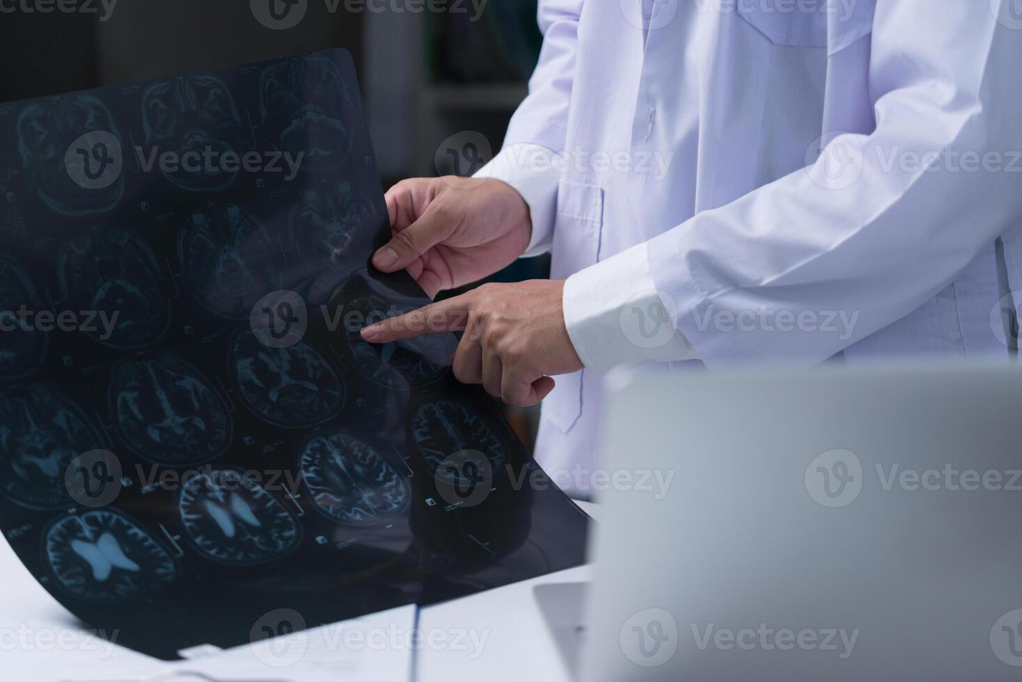 doctor checking x-ray MRI bone and CT scan film at the hospital. Healthcare and medicine concept photo