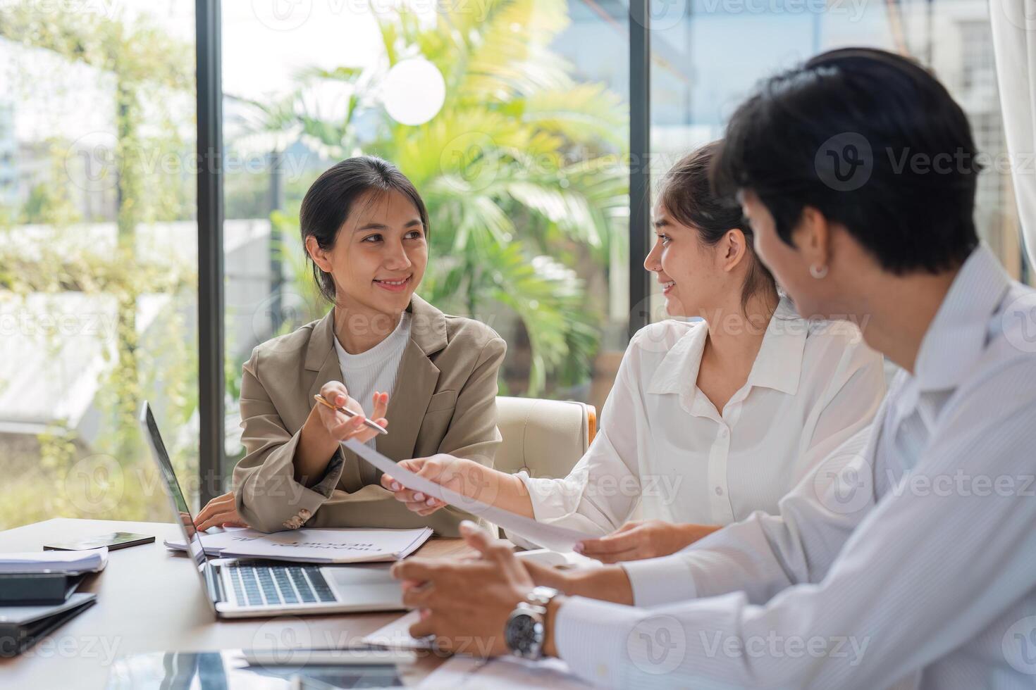 Diverse Team of Business Professionals Collaborating and Sharing Ideas in a Modern Office Setting photo