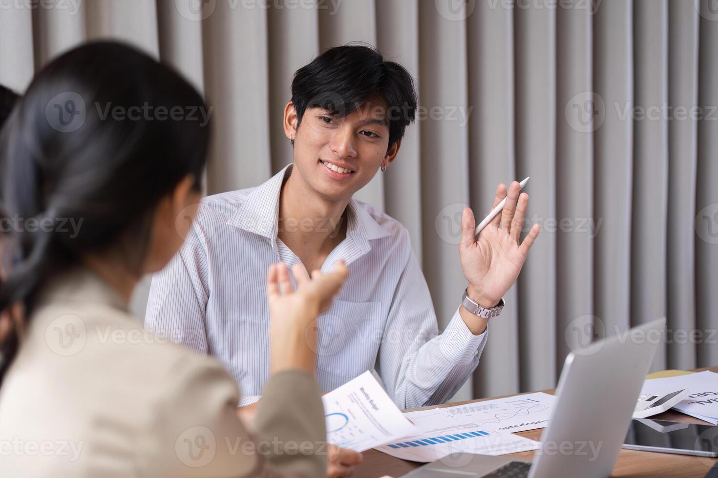 Diverse Team of Business Professionals Engaging in a Collaborative Discussion and Idea Exchange in a Modern Office Setting photo