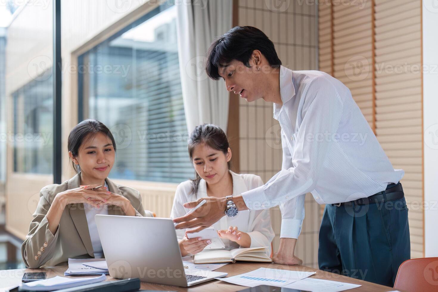 Business Team Collaborating and Exchanging Ideas in a Modern Office Setting photo