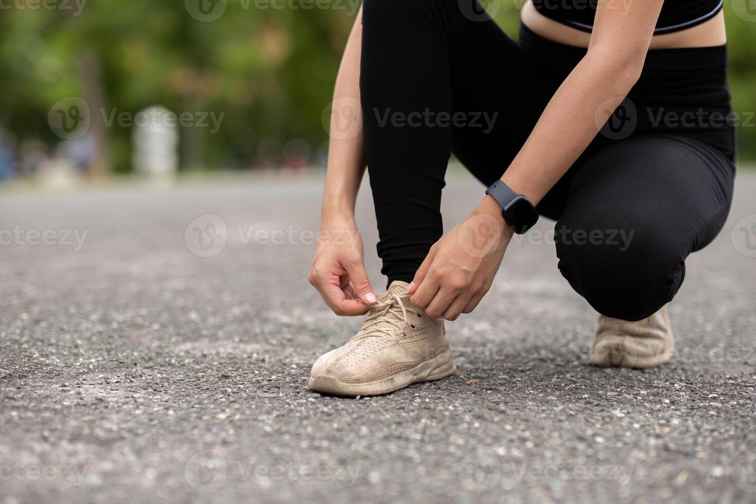 Woman Jogging in Park Tying Running Shoes, Fitness and Healthy Lifestyle Concept, Outdoor Exercise, Athletic Wear, Morning Workout photo
