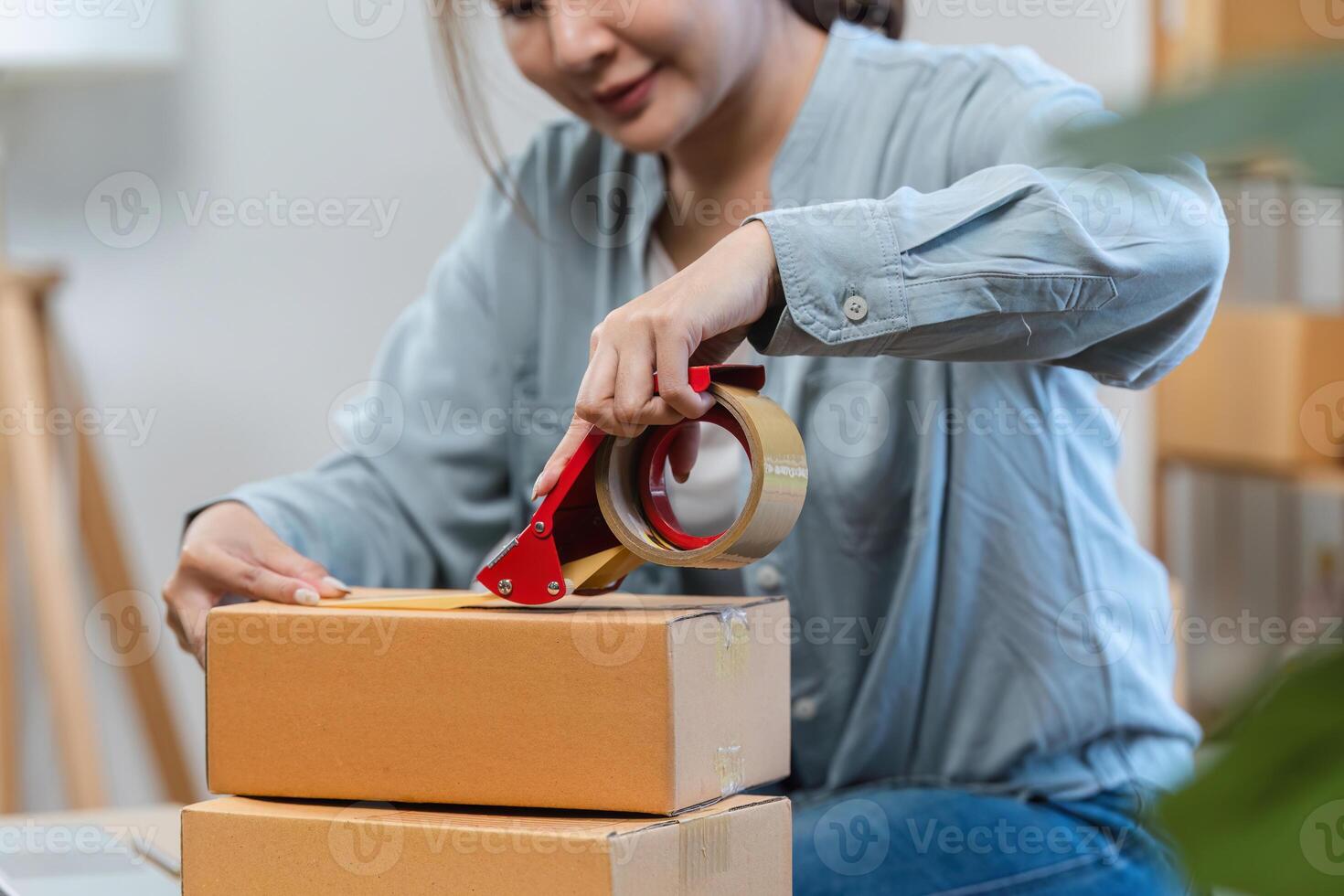 Young Woman Packing Boxes for Online Sales Business at Home Office, Small Business Owner Preparing Order photo