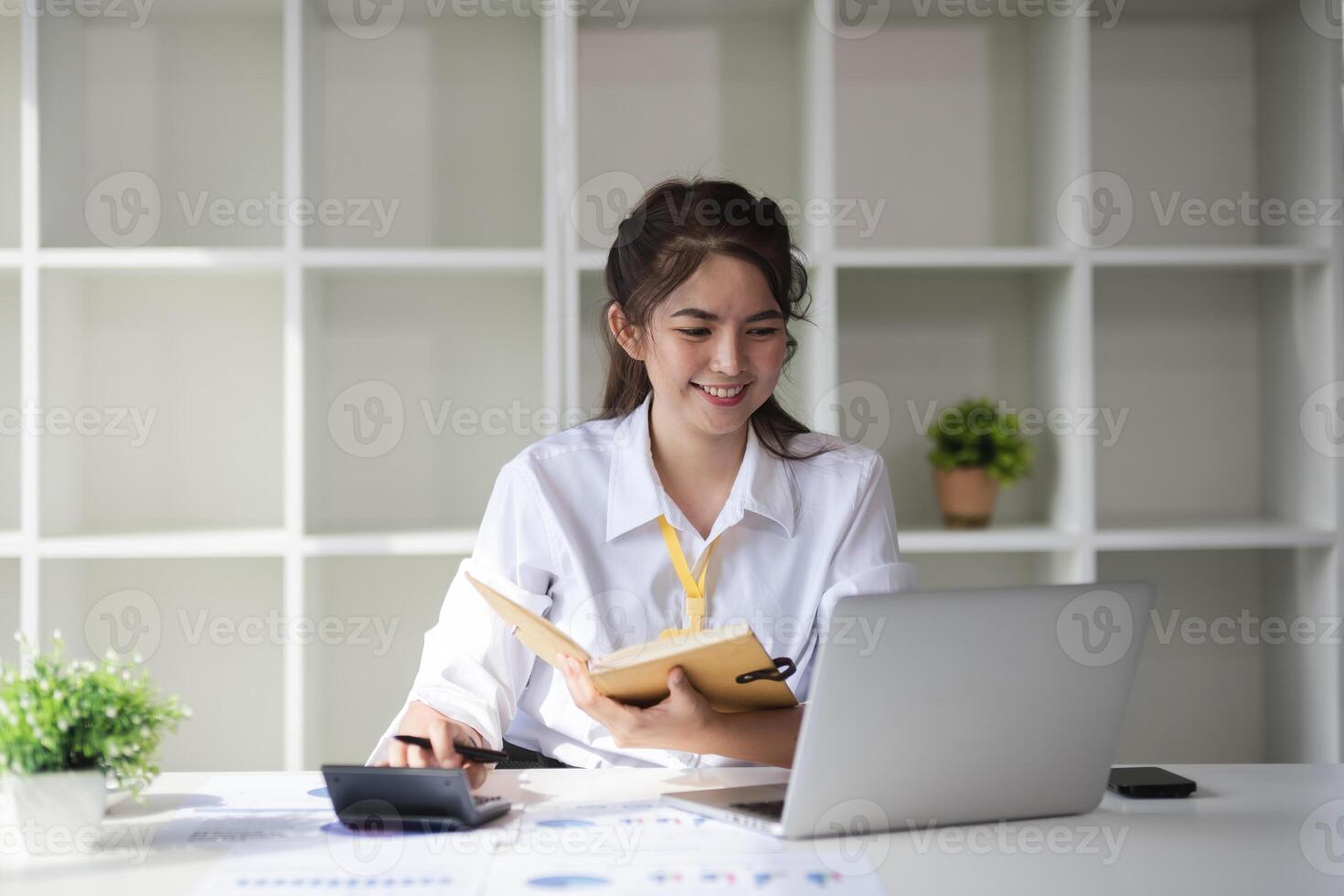 Business woman using calculator for do math finance on wooden desk in office and business working background, tax, accounting, statistics and analytic research concept. photo