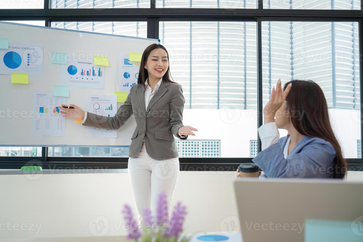 Confident Female Accountant Giving a Presentation and Exchanging Ideas in a Modern Office Setting photo