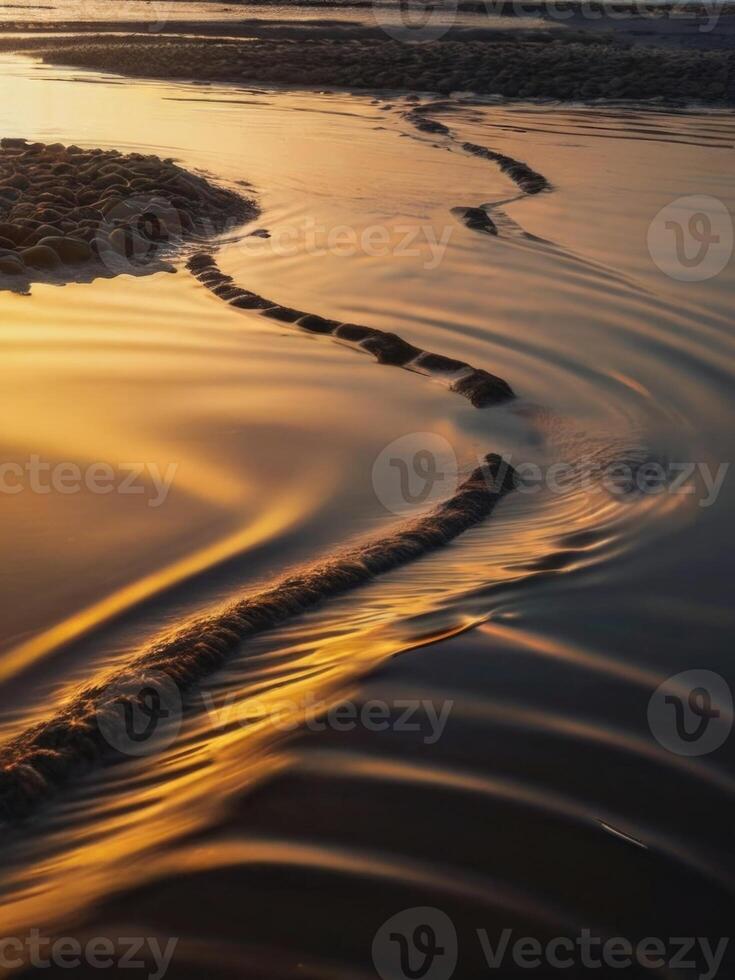 a wave on the beach at sunset photo