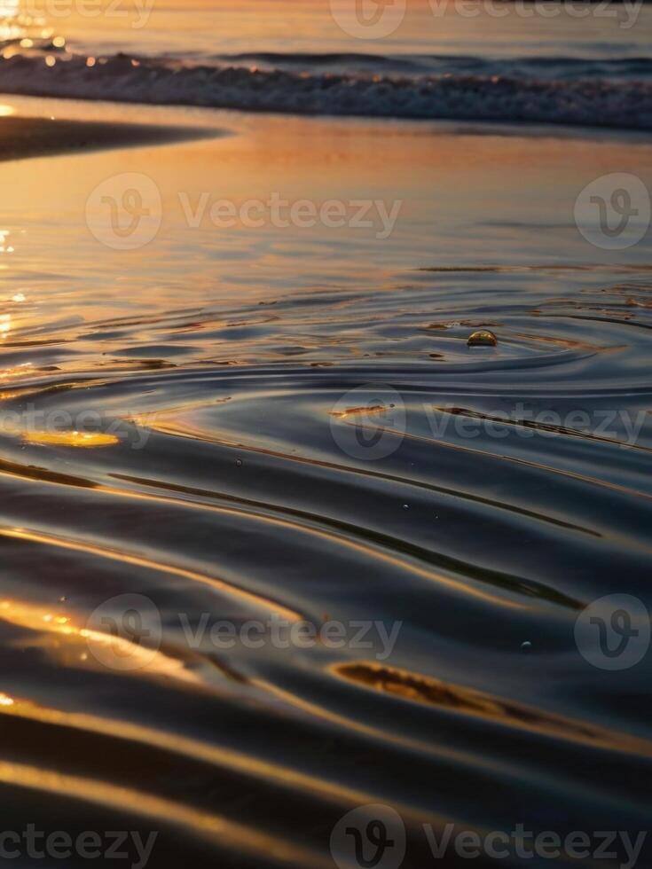 a wave on the beach at sunset photo