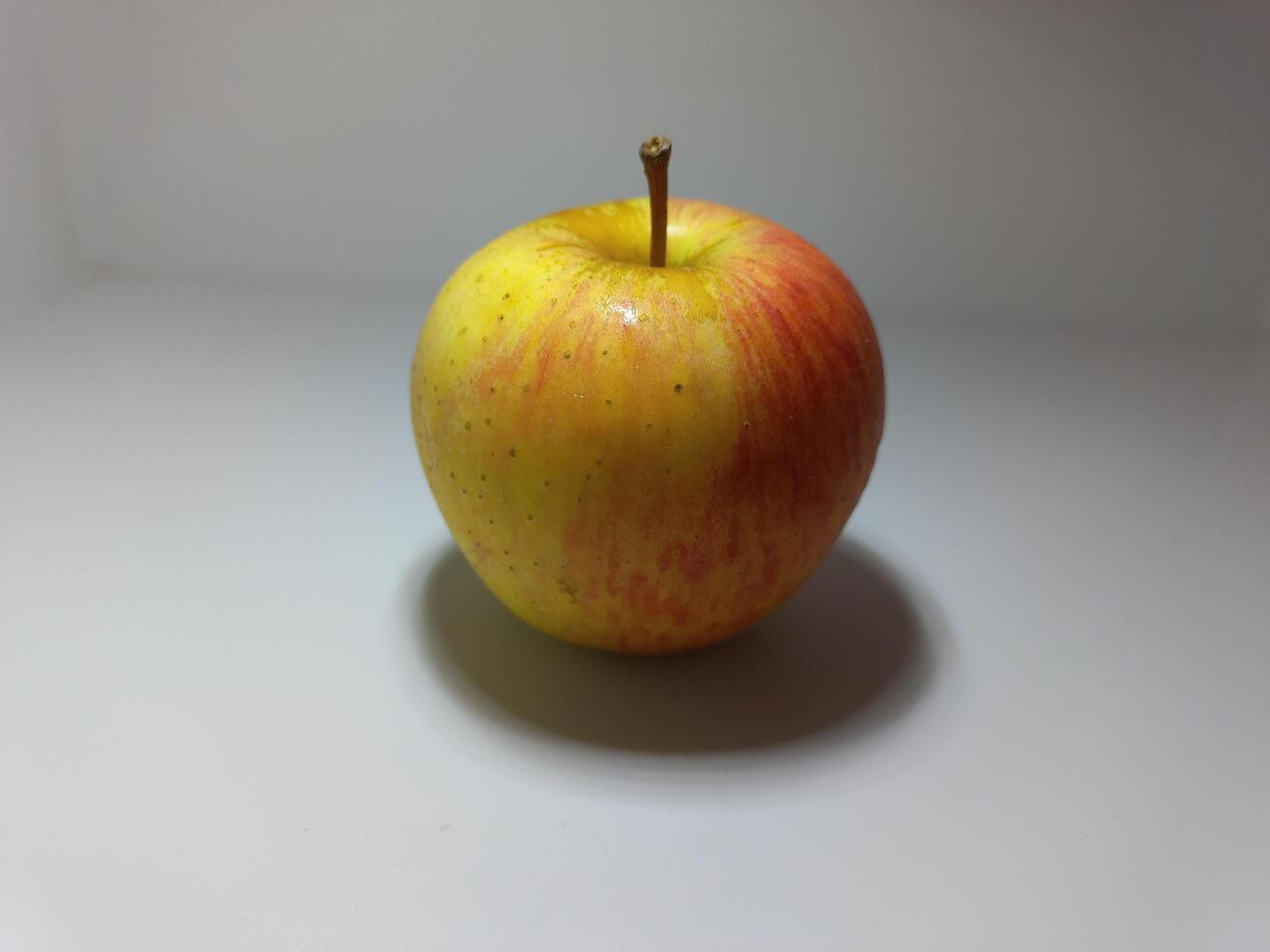 Ripe apple on a white background. Fresh raw organic fruit. photo