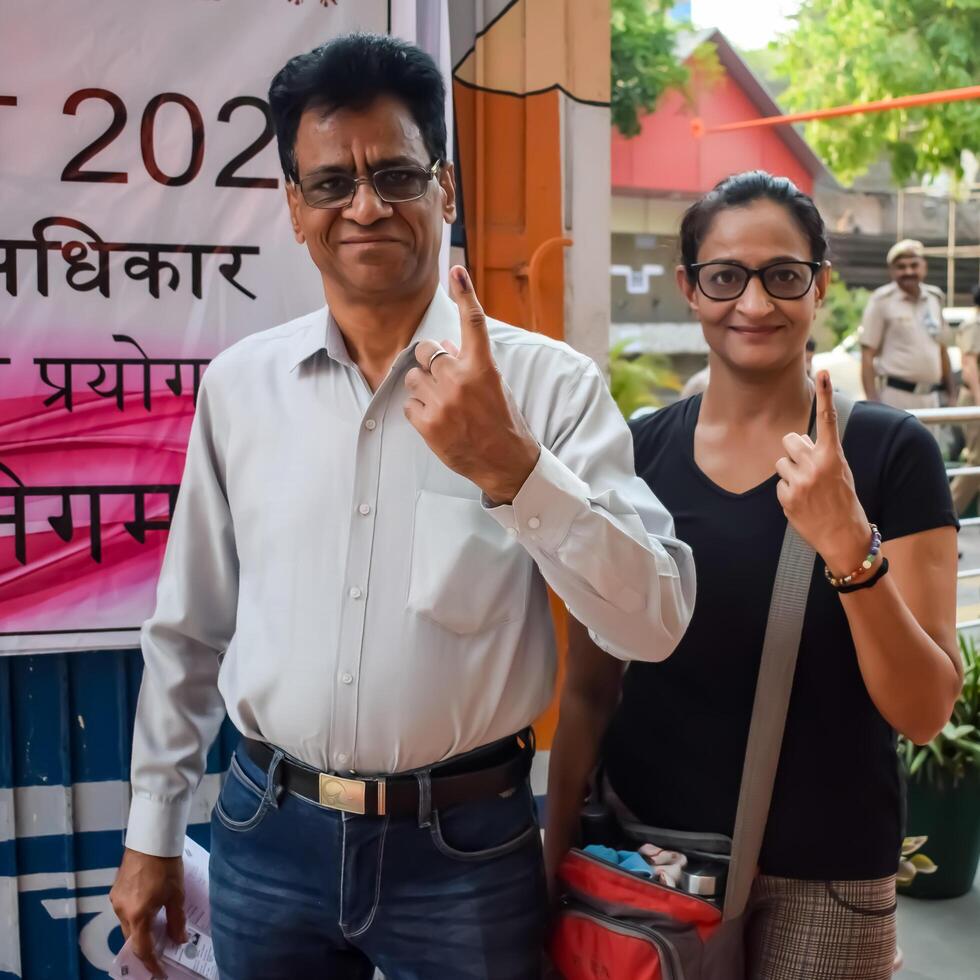 New Delhi, India - May 25 2024 - Unidentified people showing their ink-marked fingers after casting votes in front of polling booth of east Delhi area for general Lok Sabha Elections 2024 photo