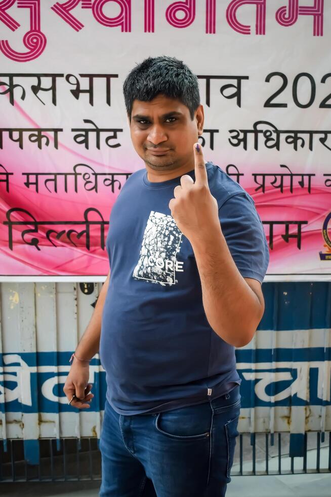 New Delhi, India - May 25 2024 - Unidentified people showing their ink-marked fingers after casting votes in front of polling booth of east Delhi area for general Lok Sabha Elections 2024 photo