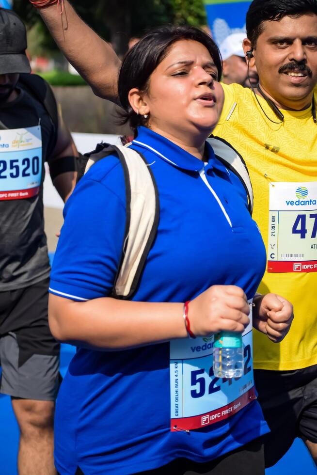 New Delhi, India - June 30 2024 - Vedanta Delhi Half Marathon race after covid in which marathon participants about to cross the finish line, Delhi Half Marathon 2023 photo