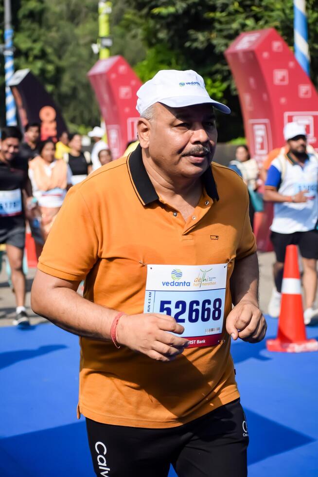 New Delhi, India - June 30 2024 - Vedanta Delhi Half Marathon race after covid in which marathon participants about to cross the finish line, Delhi Half Marathon 2023 photo