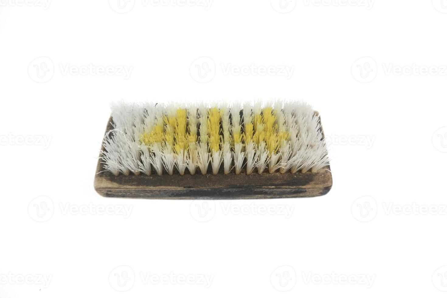 Old traditional manual clothes brusher made of wood on white background. Isolated white background. photo