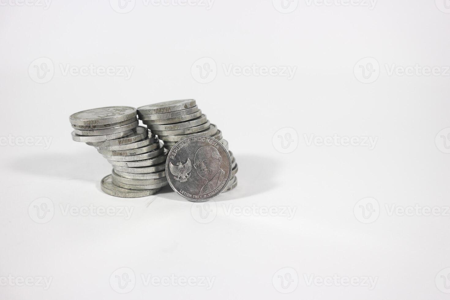 collection of Indonesian rupiah coins on a white background. Stack of Indonesian rupiah coins. Stack of Silver Coins. Financial concept. Copy space. isolated on white photo