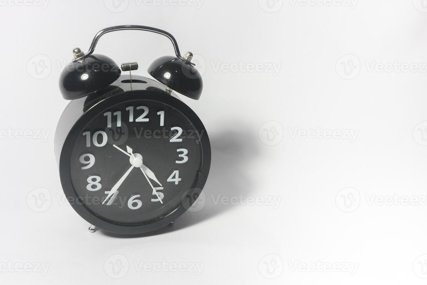 Classic black table clock isolated on a white background. copy space photo