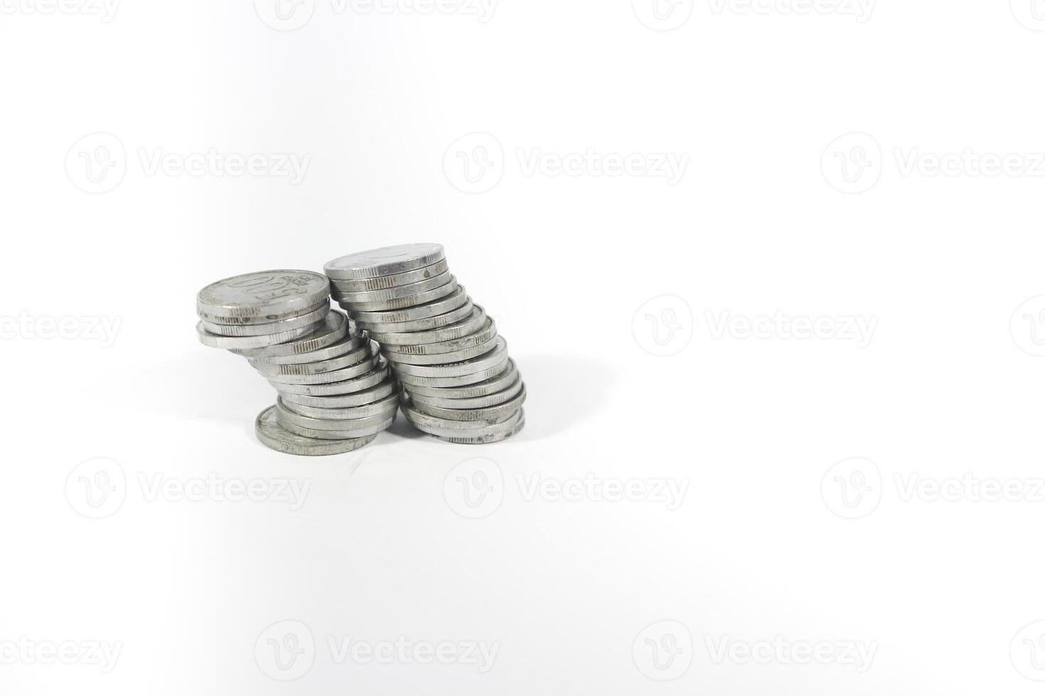 collection of Indonesian rupiah coins on a white background. Stack of Indonesian rupiah coins. Stack of Silver Coins. Financial concept. Copy space. isolated on white photo