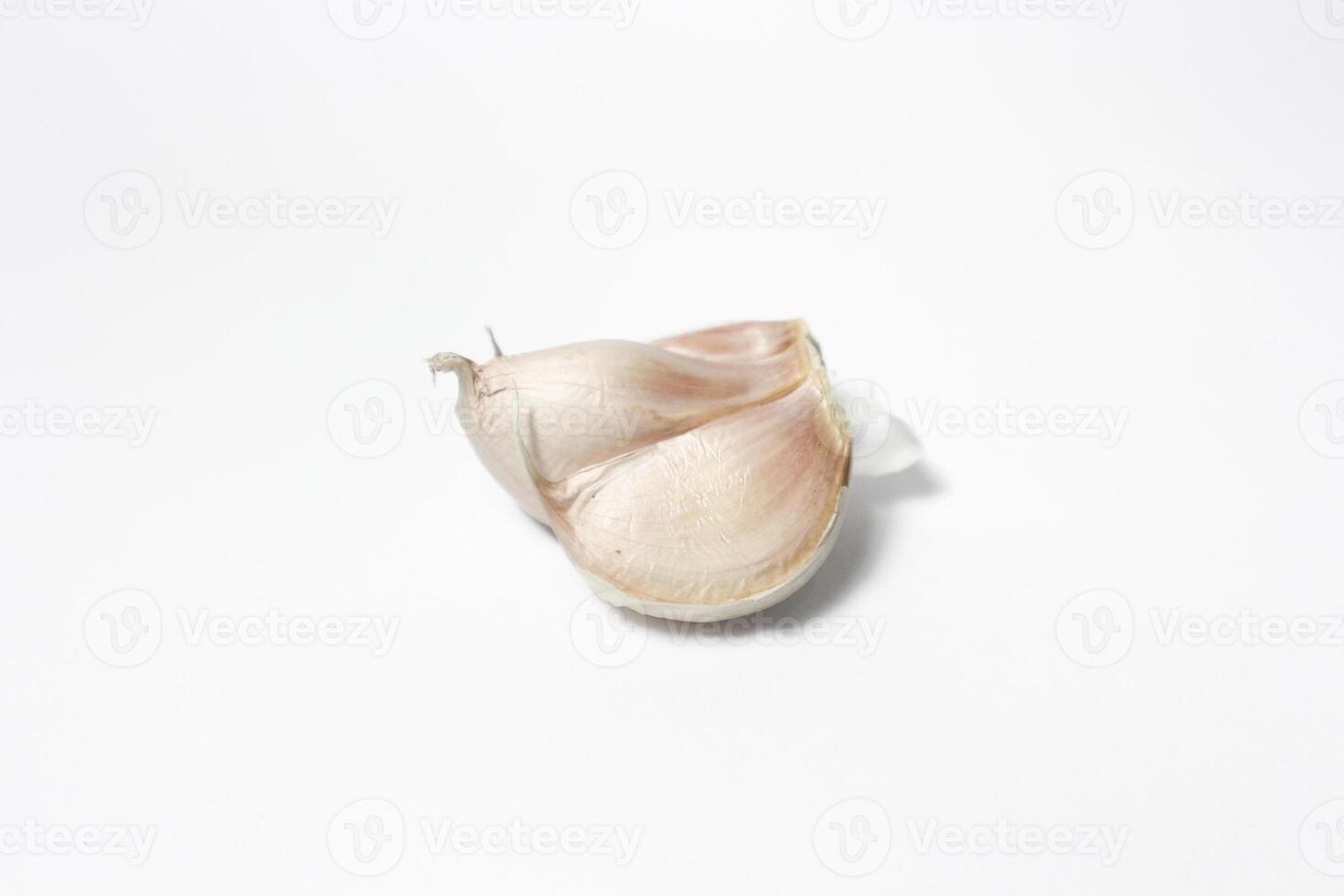 A piece of garlic isolated. Raw garlic with segments isolated on white background. photo
