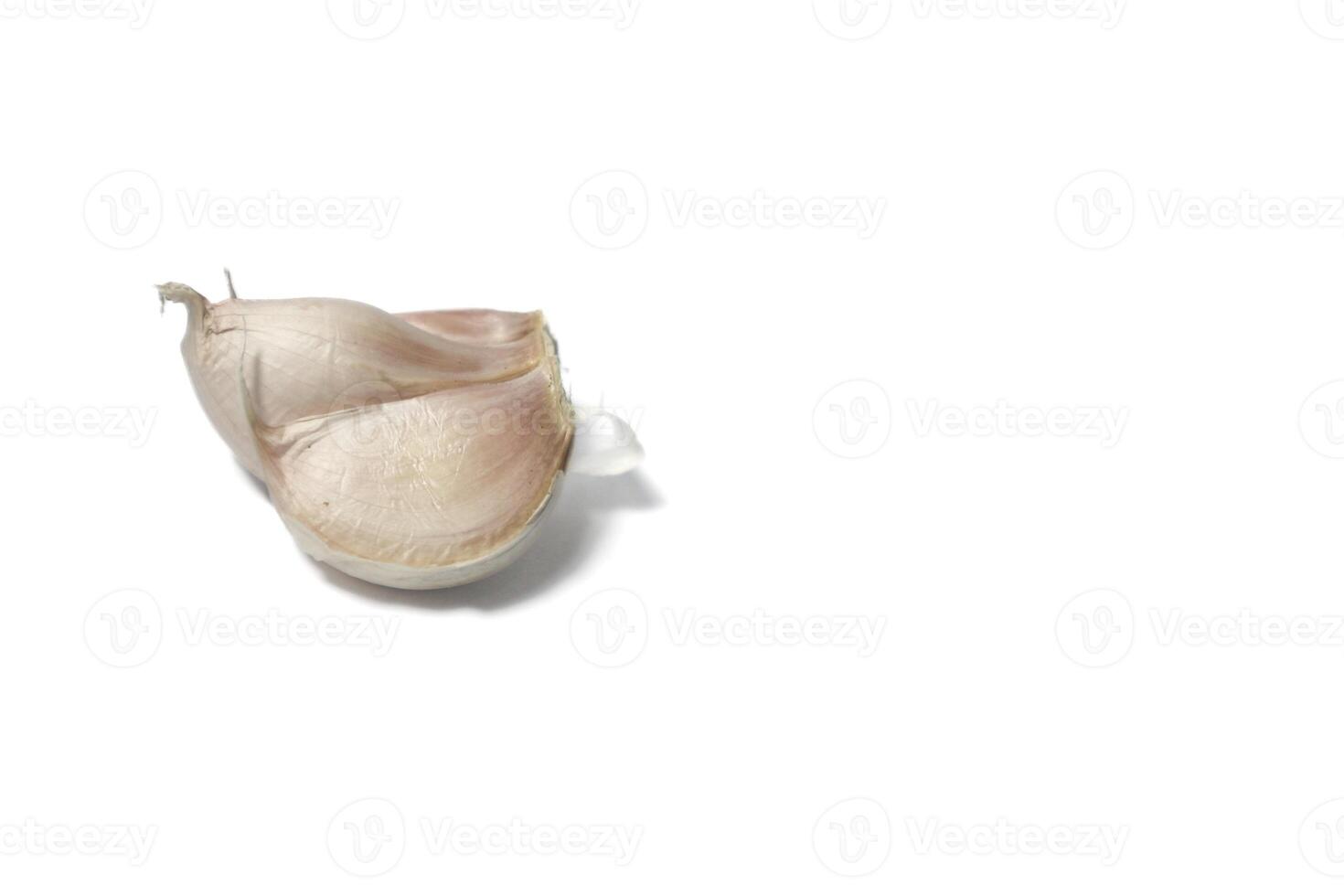 A piece of garlic isolated. Raw garlic with segments isolated on white background. photo