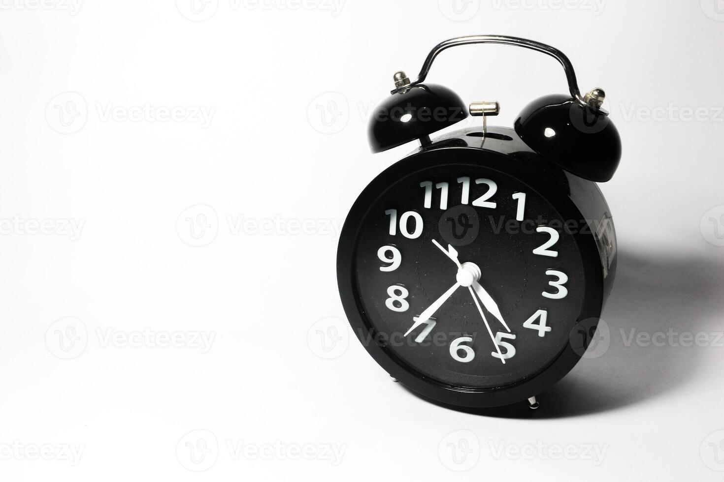 Classic black table clock isolated on a white background. copy space photo