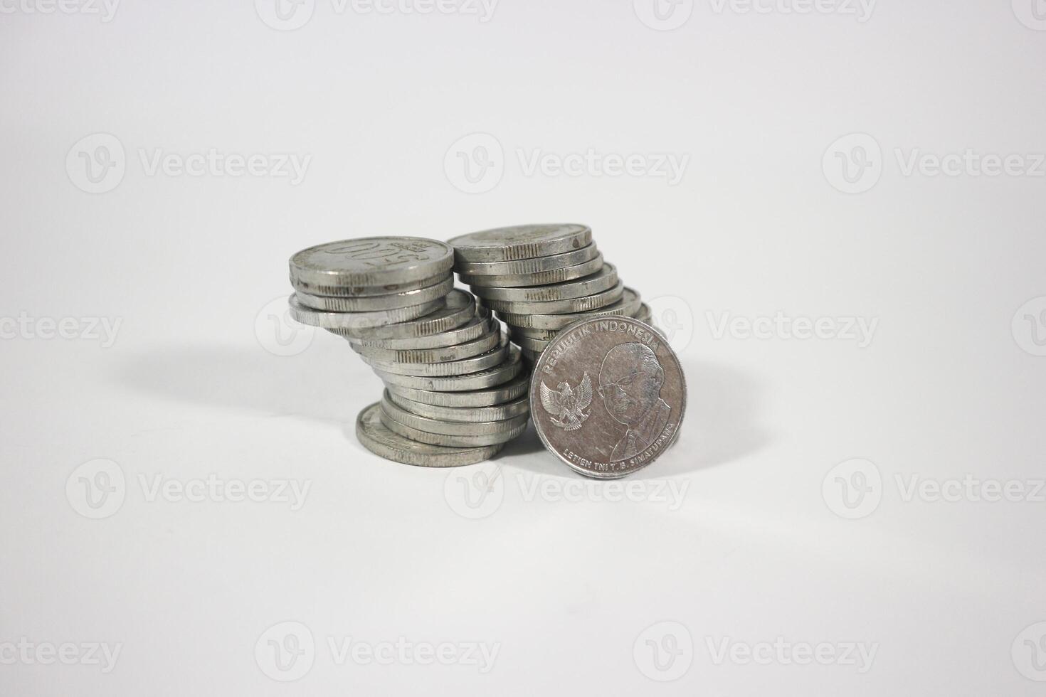 collection of Indonesian rupiah coins on a white background. Stack of Indonesian rupiah coins. Stack of Silver Coins. Financial concept. Copy space. isolated on white photo