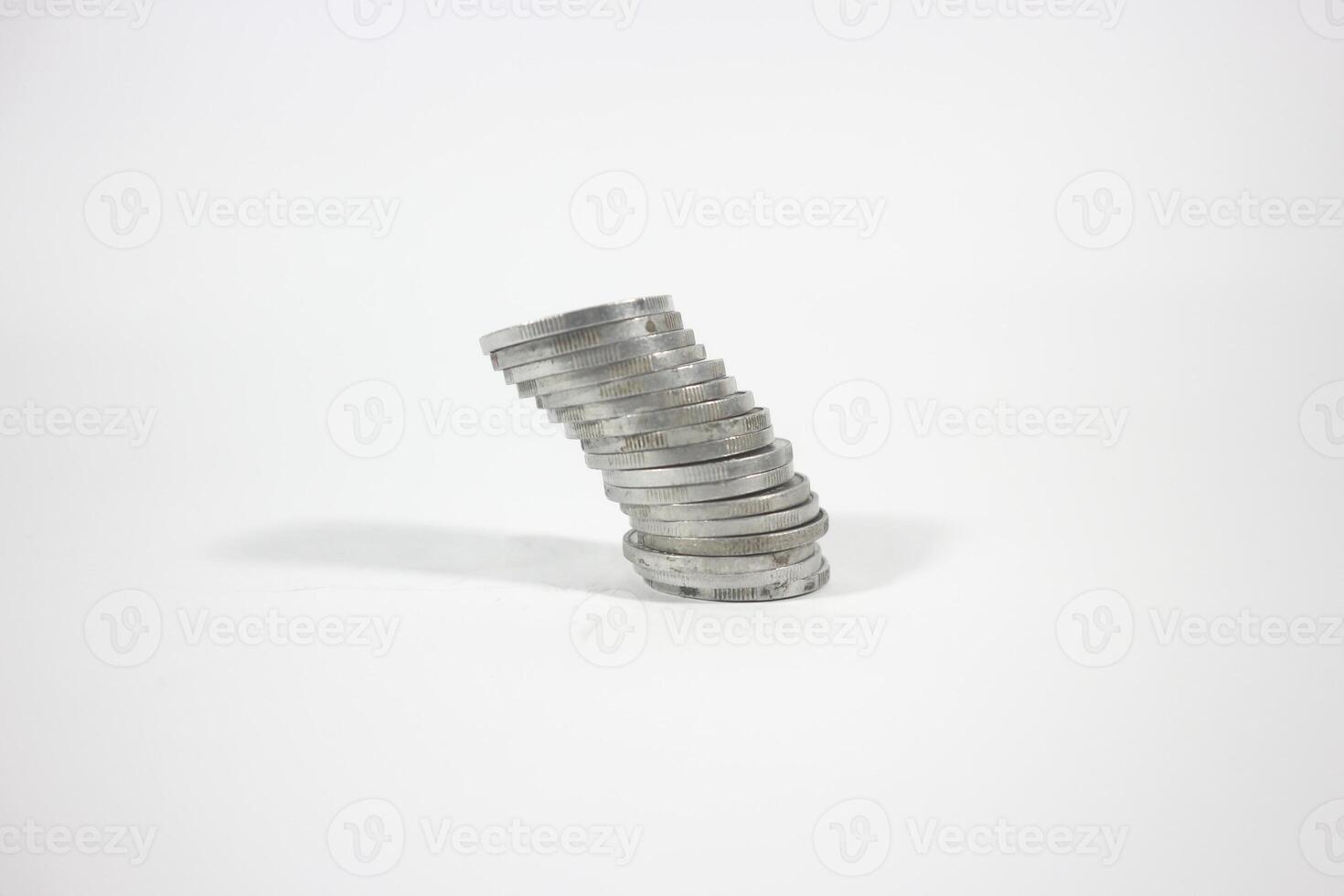 tilted stack of Indonesian rupiah coins. debt concept. isolated background photo