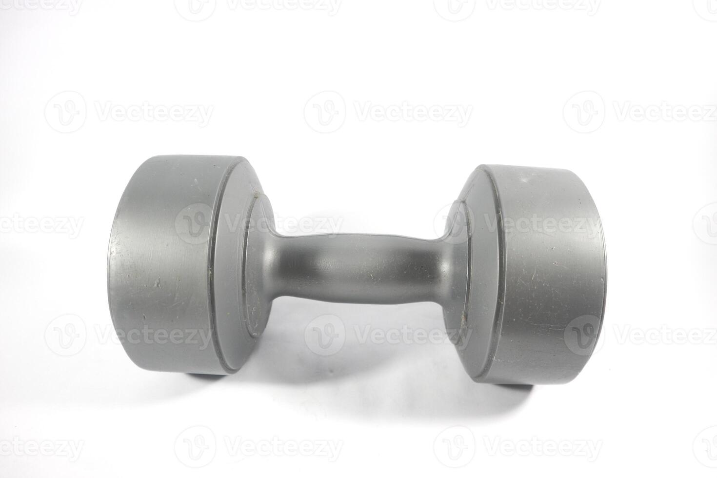 One gray color dumbbells or barbell isolated on white background. Dumbbells on white background photo