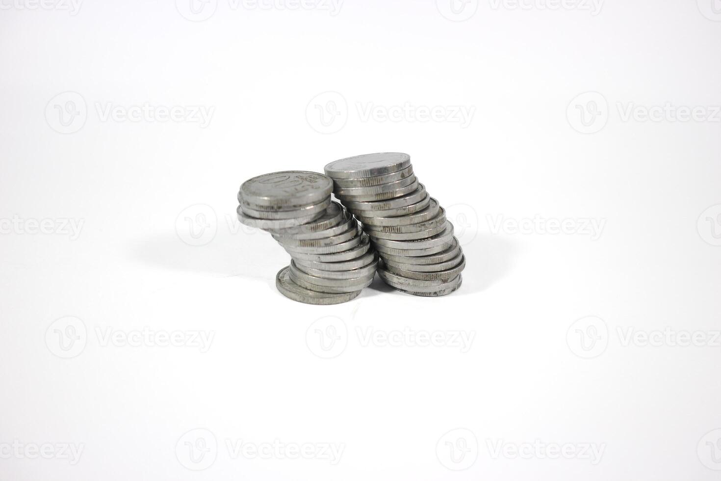 collection of Indonesian rupiah coins on a white background. Stack of Indonesian rupiah coins. Stack of Silver Coins. Financial concept. Copy space. isolated on white photo