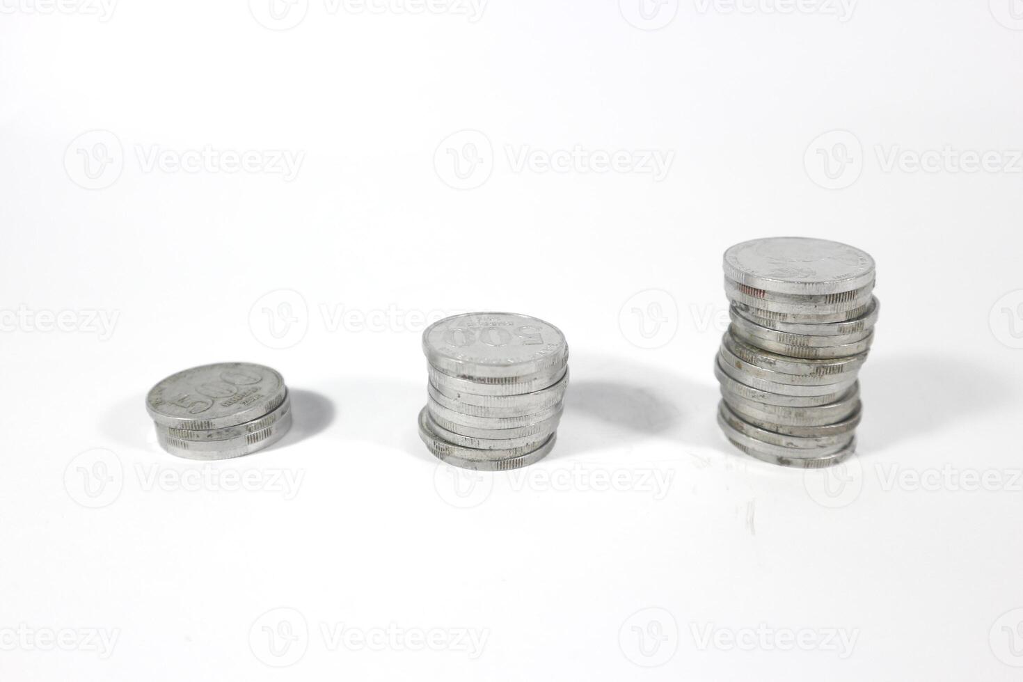 Coin on white background, stacked coins, isolated, sort by level, Indonesian Rupiah. investment and saving concept photo