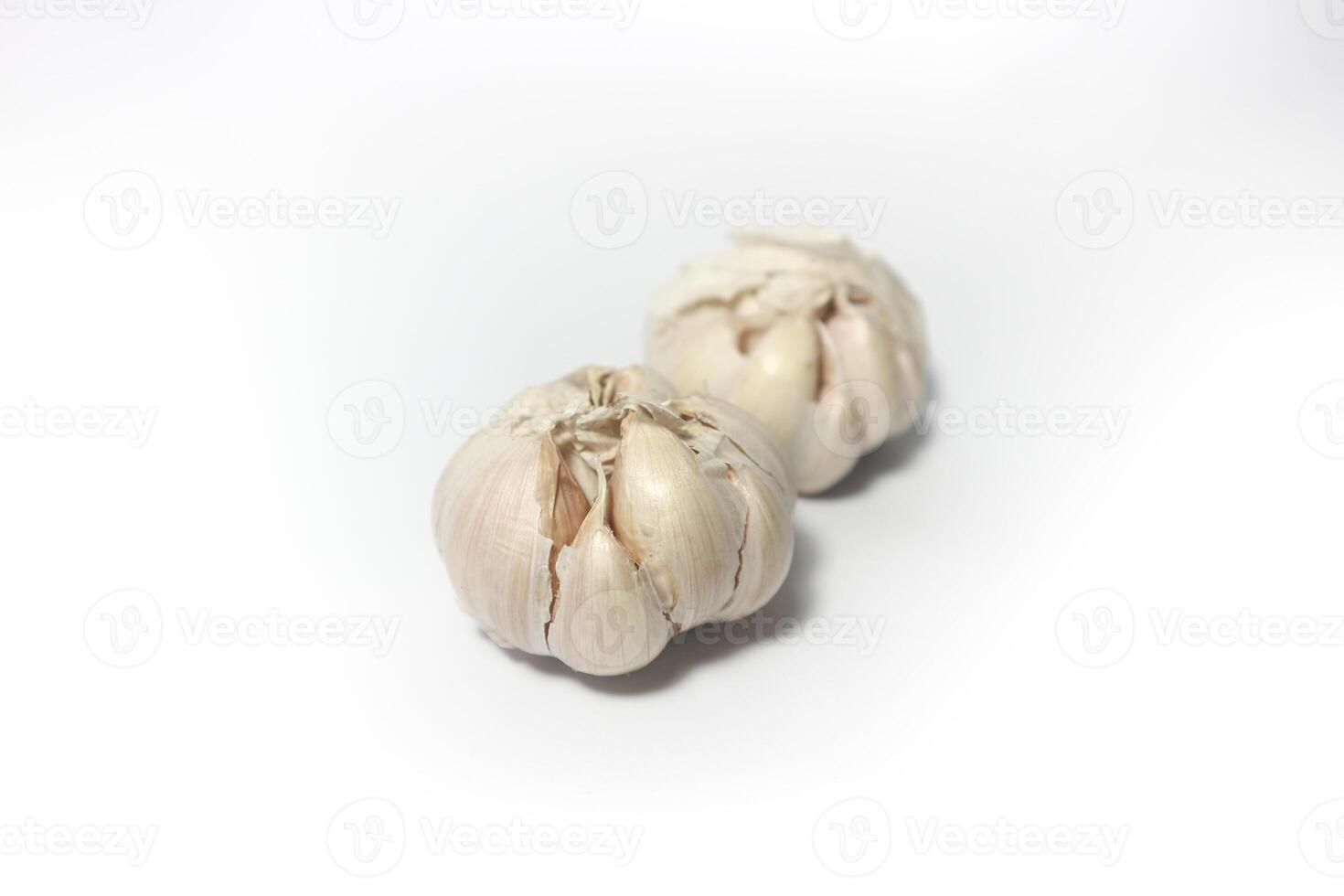 Two Garlic isolated. Raw garlic with segments isolated on white background. photo