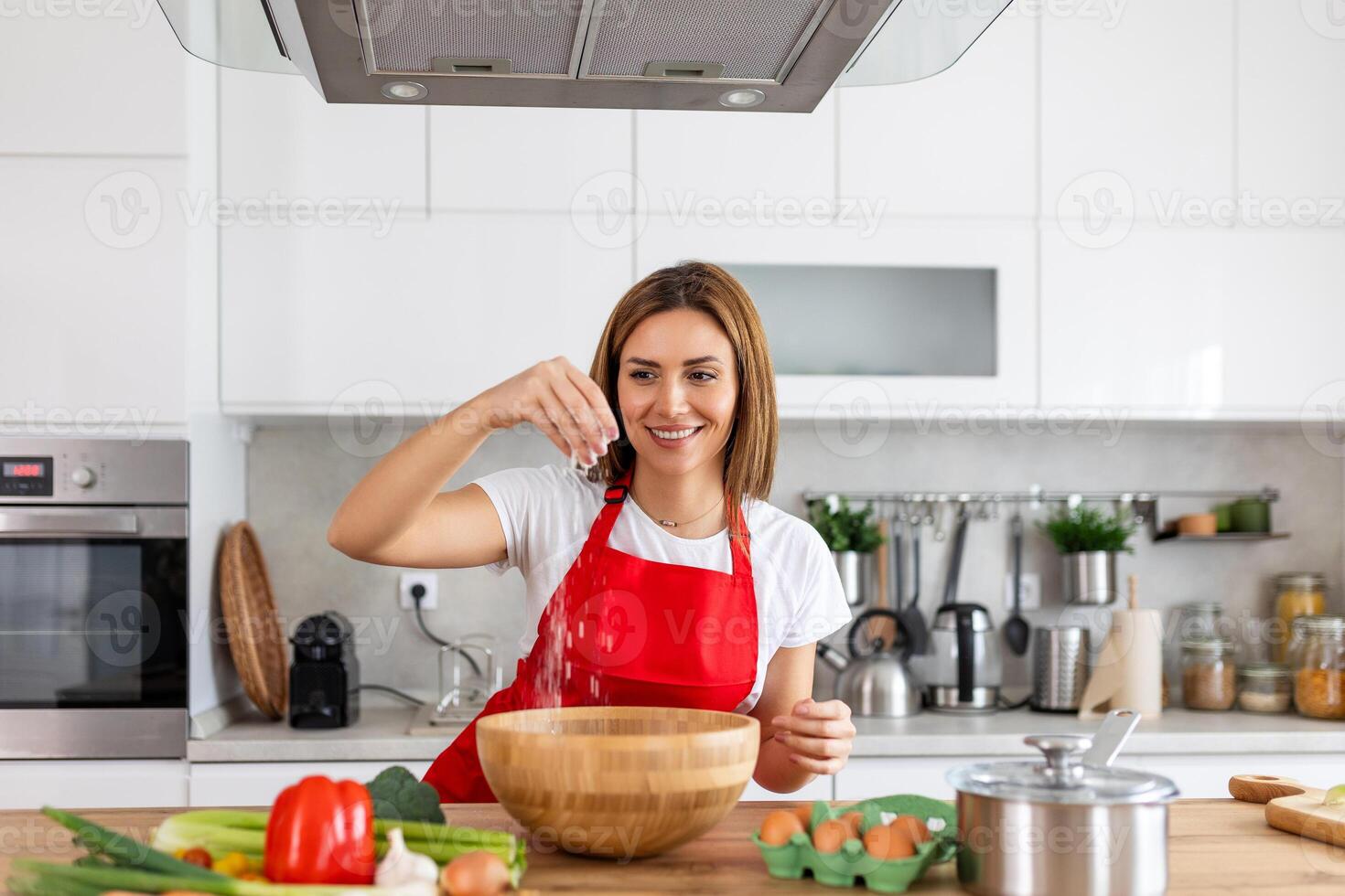 Happy attractive young adult woman housewife baker wear apron holding pin rolling dough on kitchen table baking pastry concept cooking cake biscuit doing bakery making homemade pizza at home photo