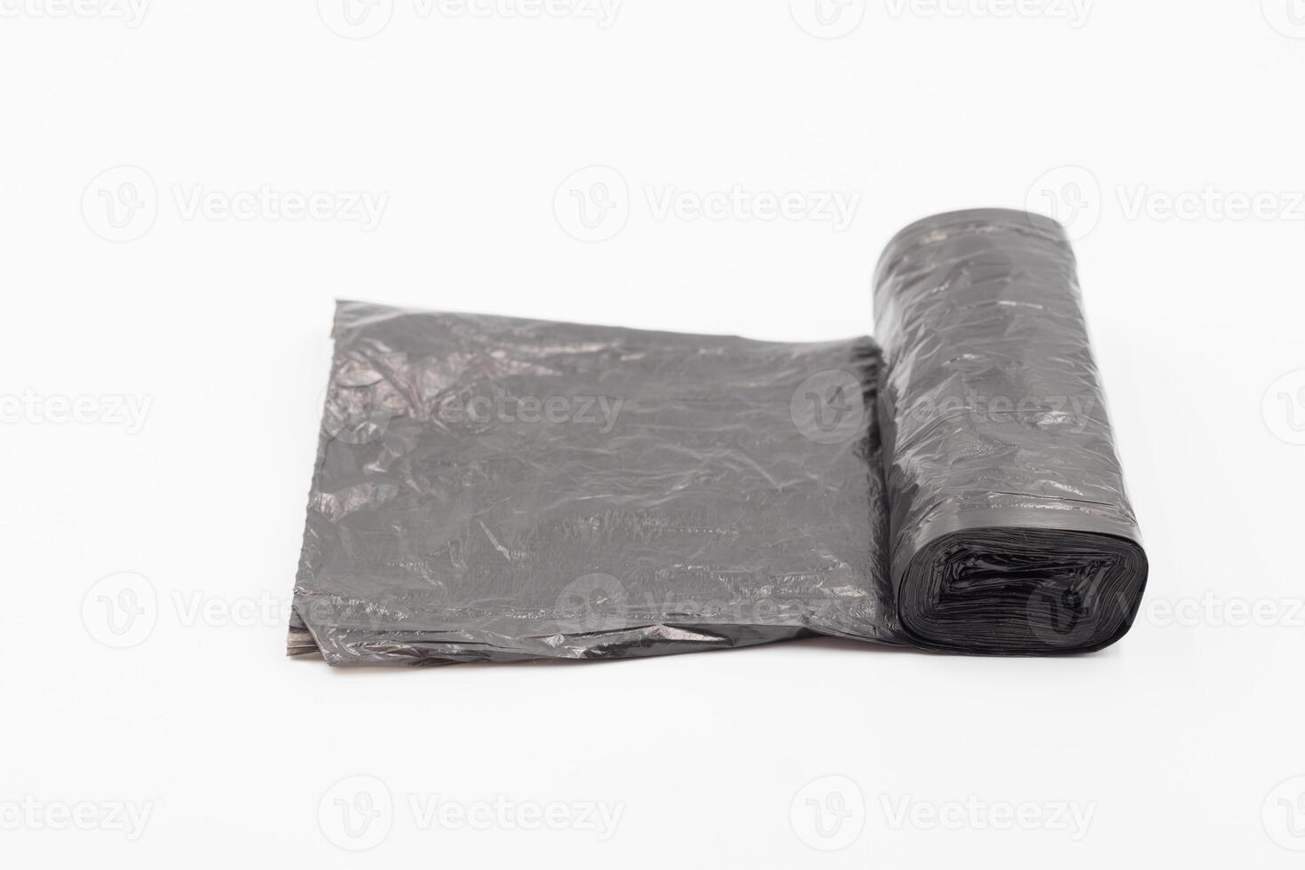 Black plastic garbage bags on white background, Roll of garbage bags on white background photo