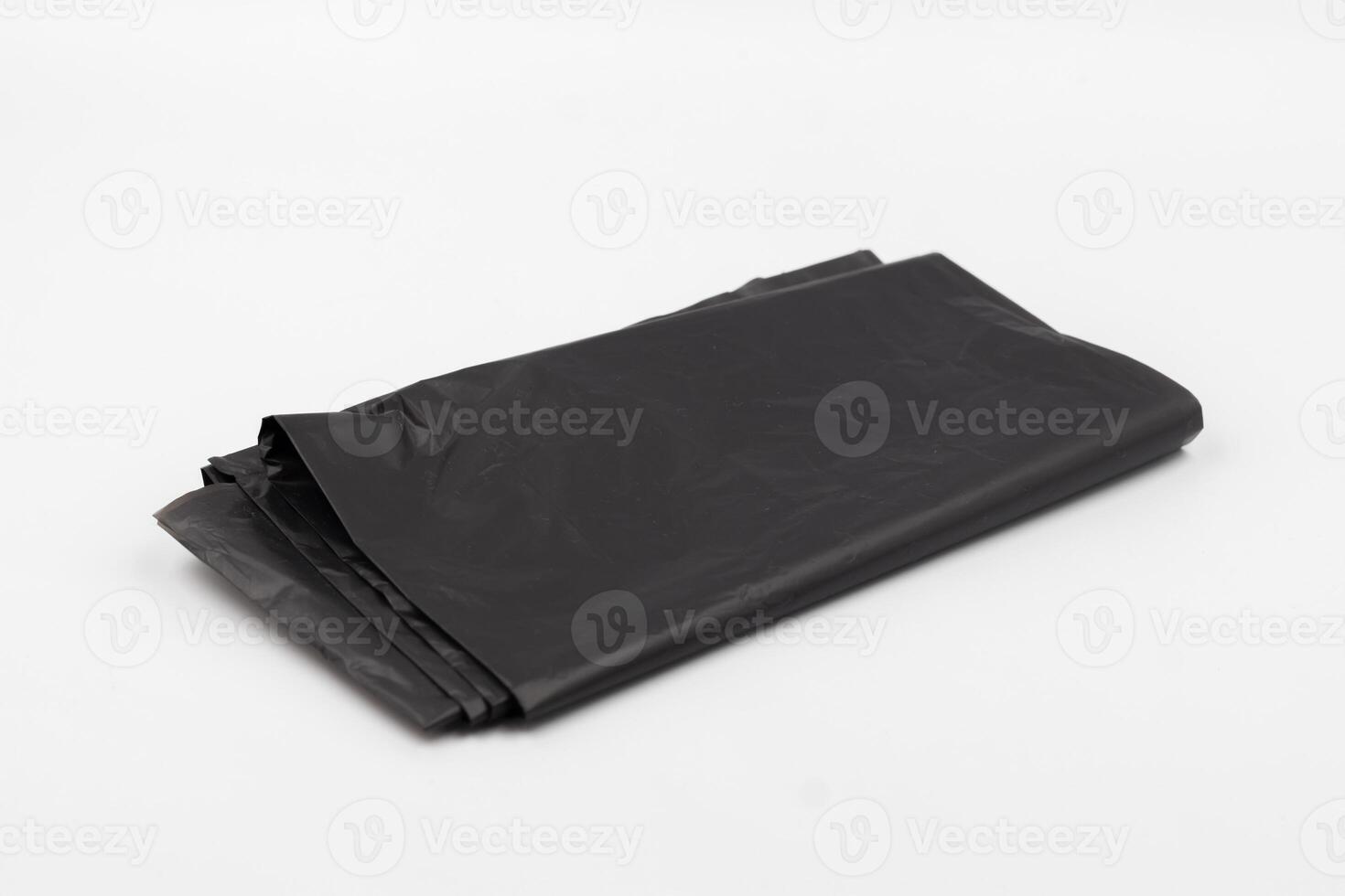 Black plastic garbage bags on white background, Roll of garbage bags on white background photo