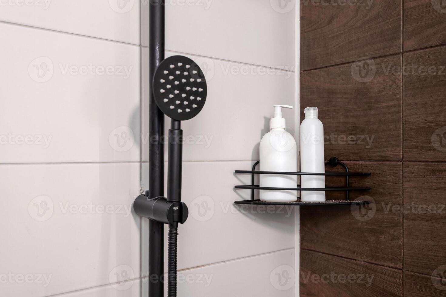 Bottles for shampoo and gel in the bathroom against the backdrop of white tiles and shower photo