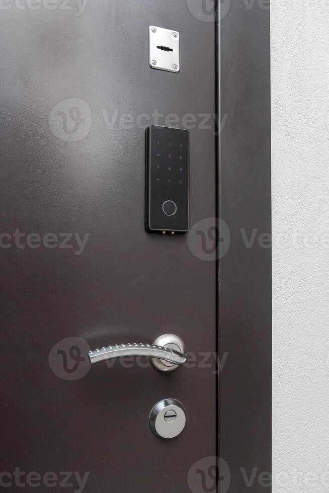 Electronic lock on the front door with fittings photo