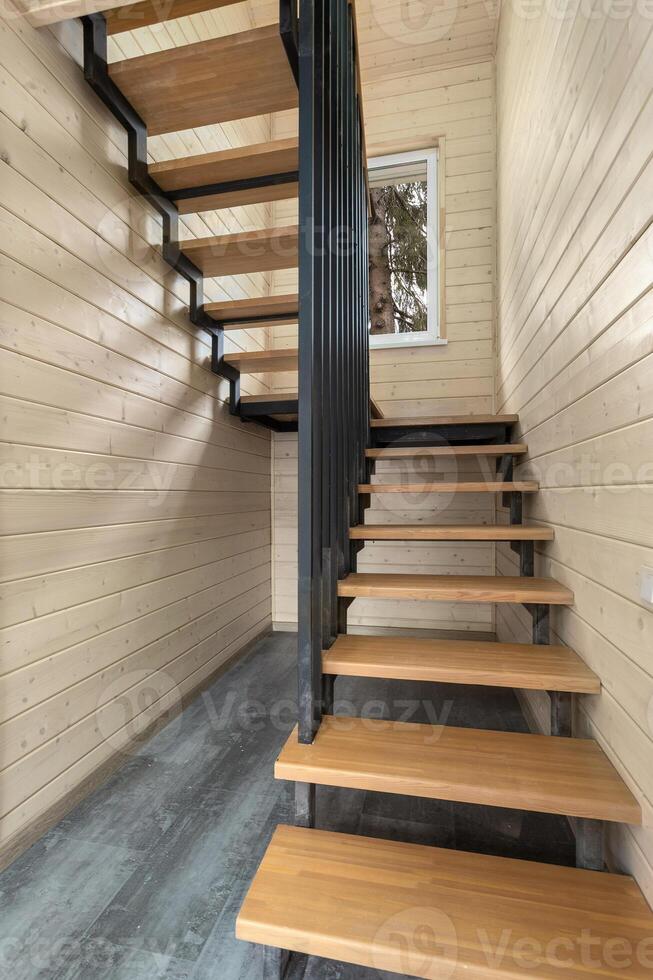 Wooden staircase in a room with wood trim photo