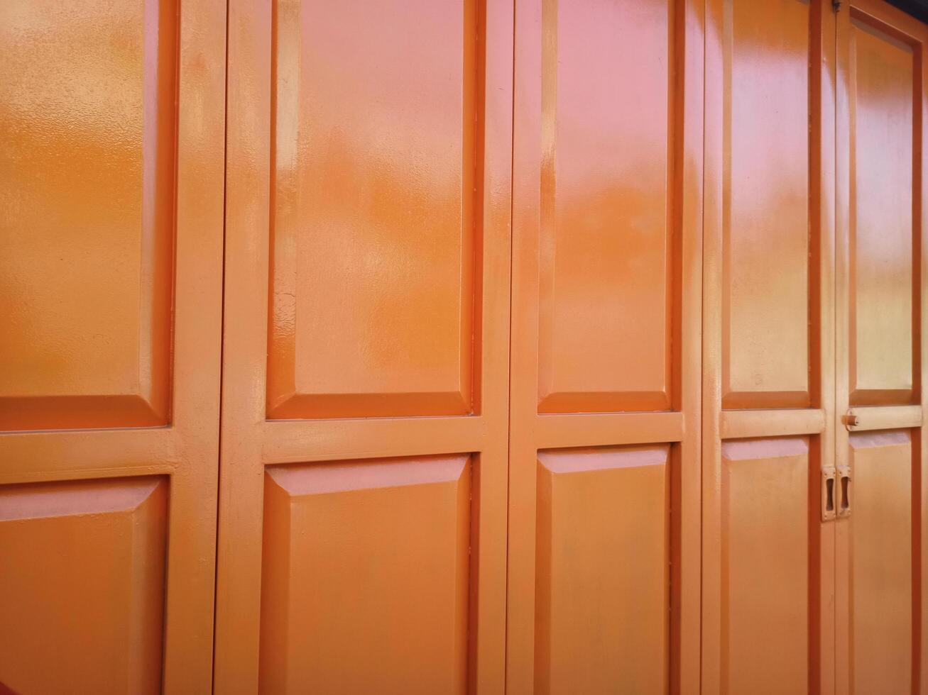 Orange folding door. The folding door of a parking room photo