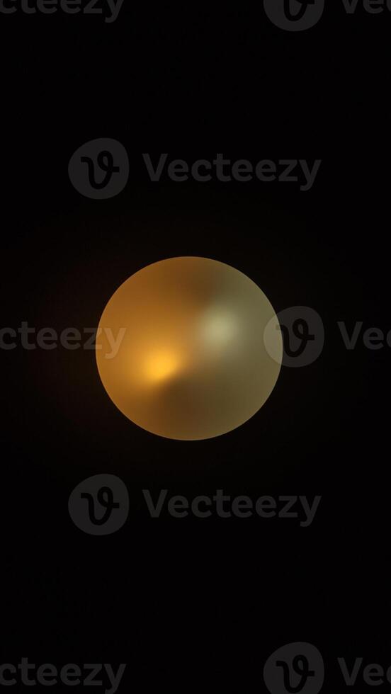 A single, round light fixture hangs in a dark room photo