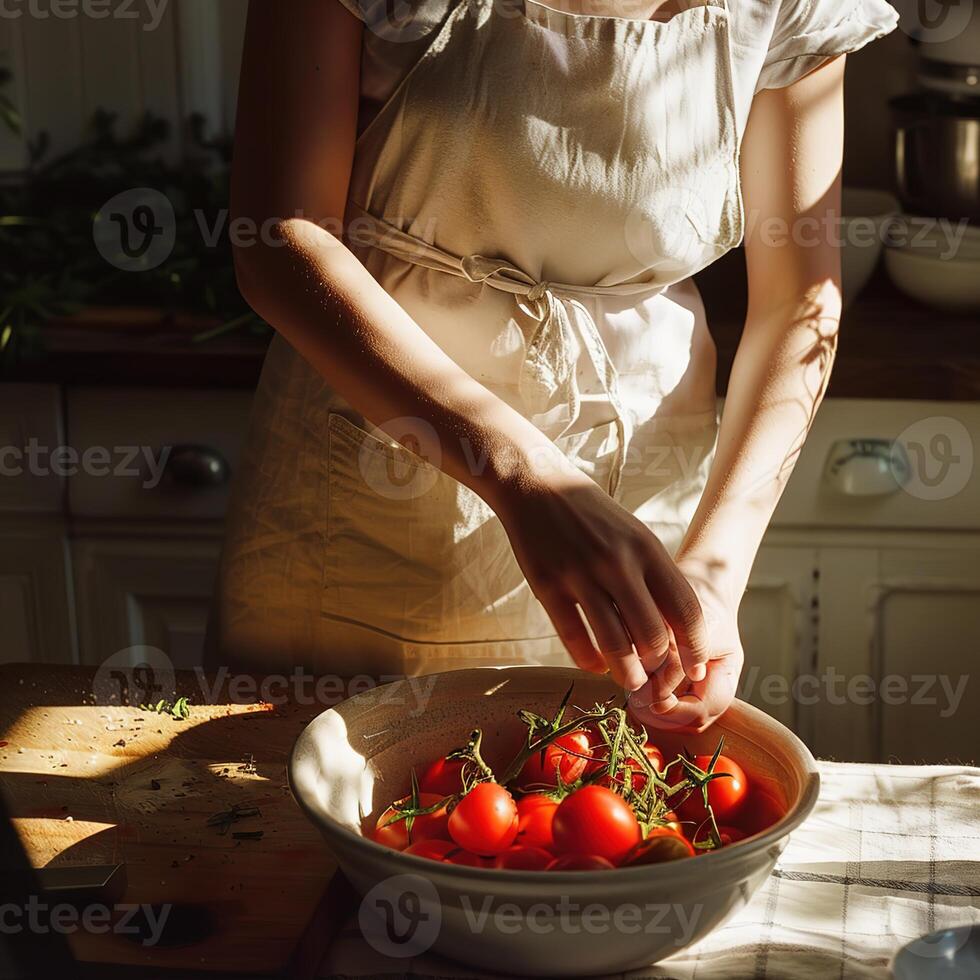A woman in casual linen outfit standing cooking with vegetables and tomatoes on the table photo