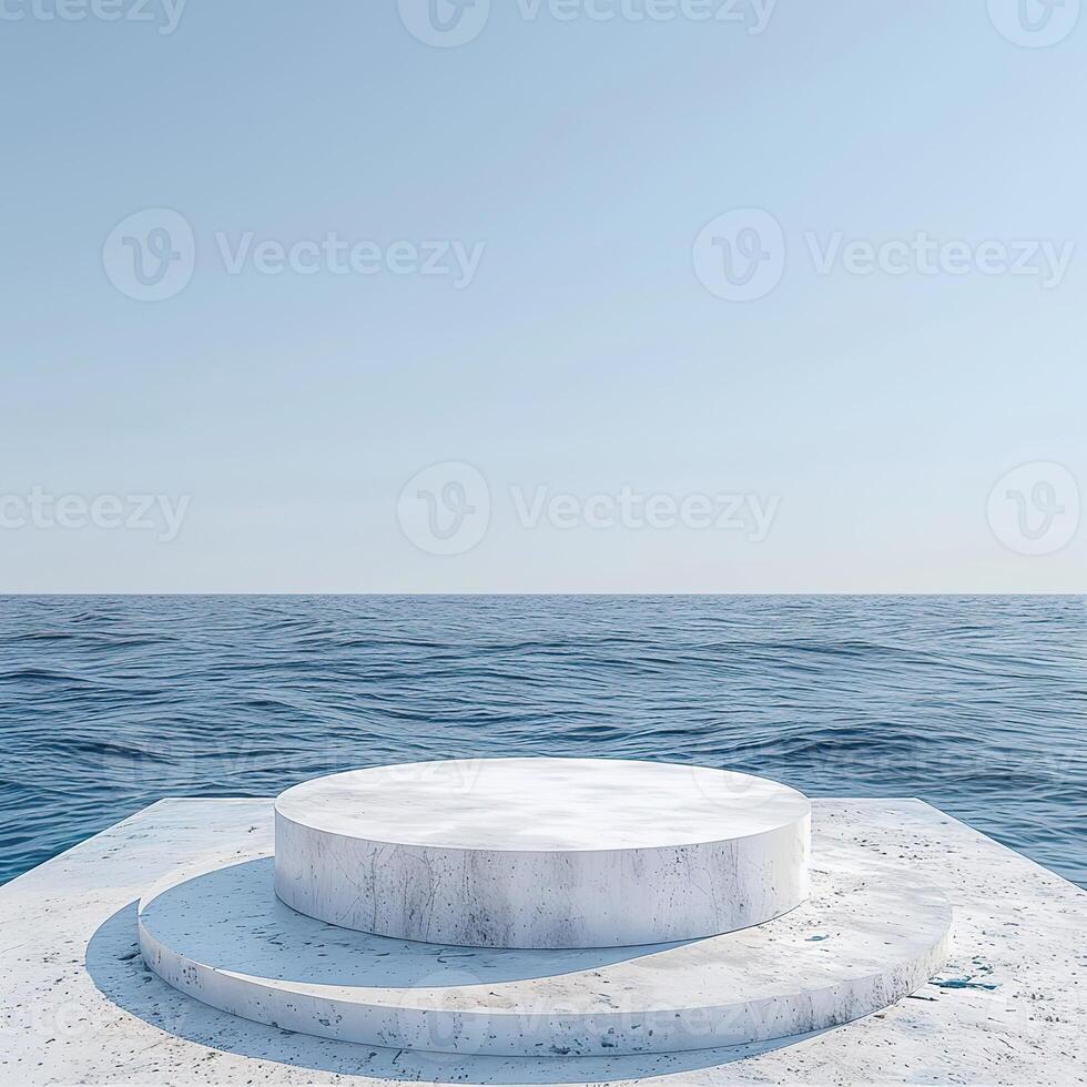 A round podium on the beach, surrounded by sand and sea in light beige tones photo