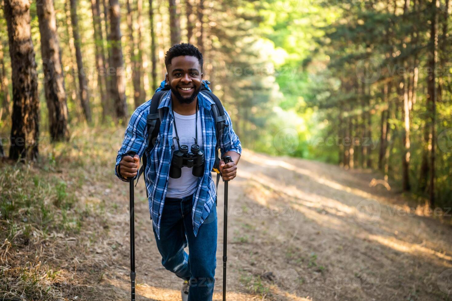 Young man enjoys hiking in nature. photo