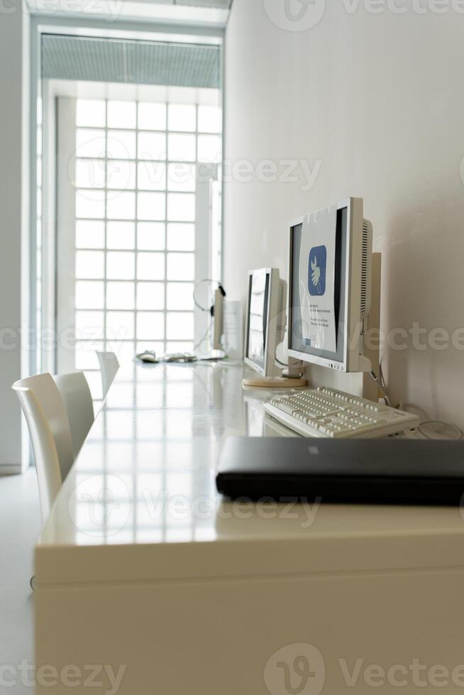 Workplace in the office. There are computers and a scanner on the table. photo