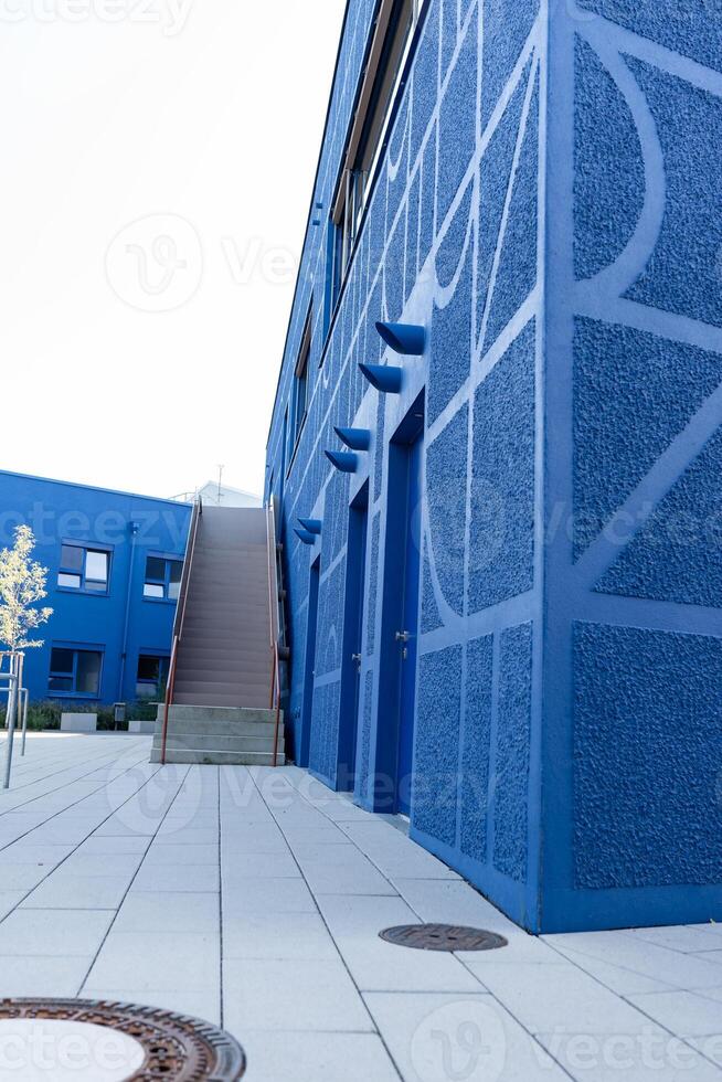 Blue buildings with a pattern on the walls. A complex of buildings painted in a bright blue color. photo