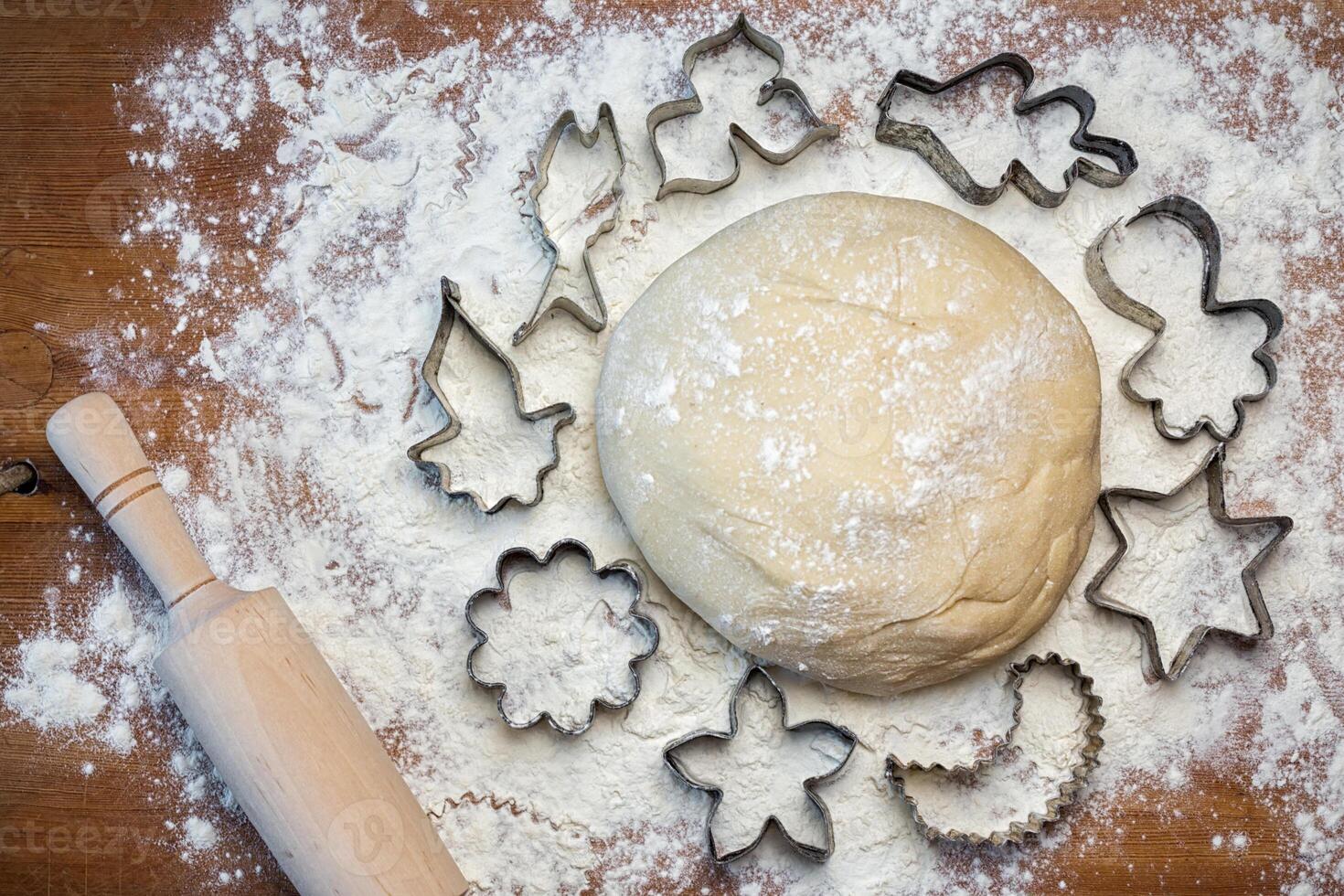 forms for squeezing the dough. dough on the table with dough tools. photo
