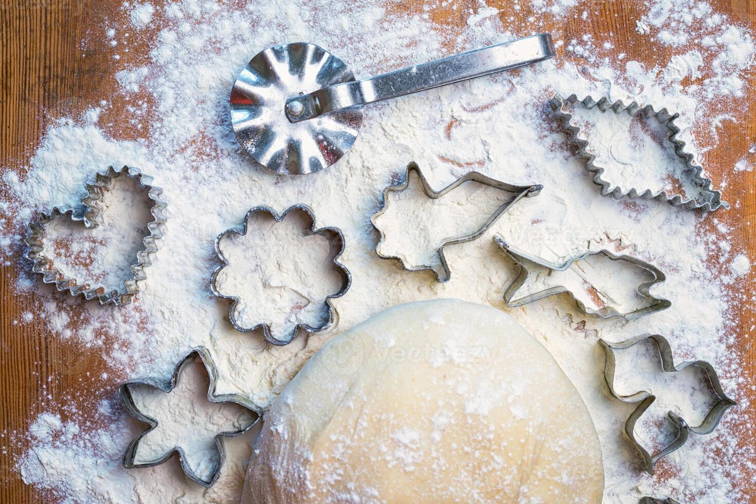 forms for squeezing the dough. dough on the table with dough tools. photo