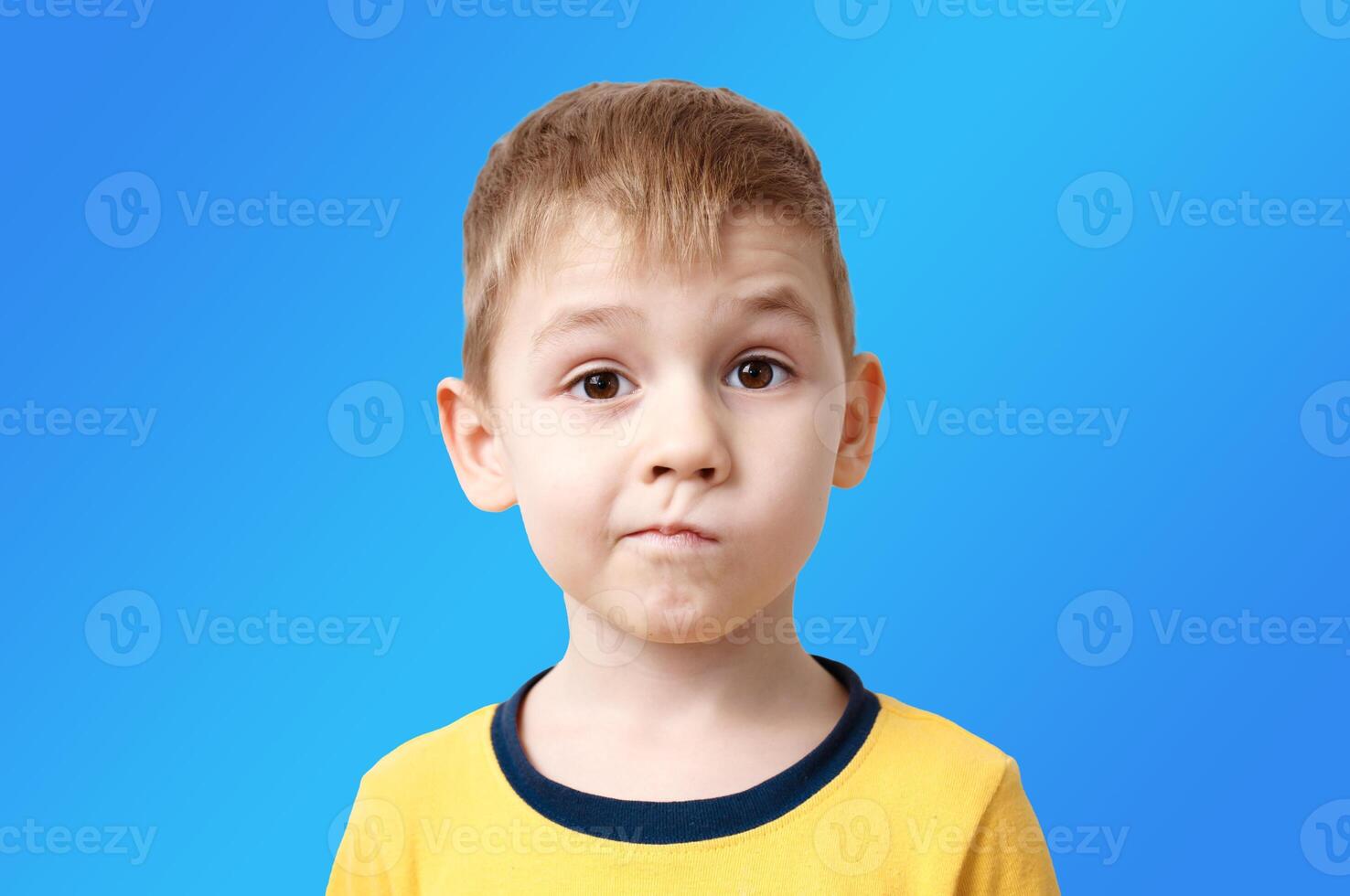 portrait of a little boy with the emotion of misunderstanding, surprise thoughts photo