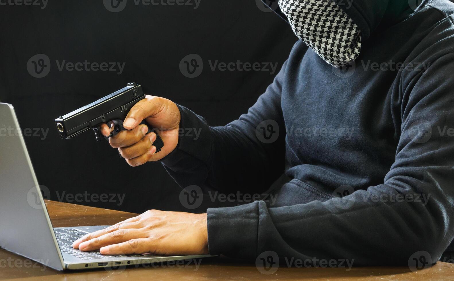 Hacker spy man one person black hoodie sitting hand holding credit card look computer laptop used login password attack security data digital internet network system night dark background copy space photo